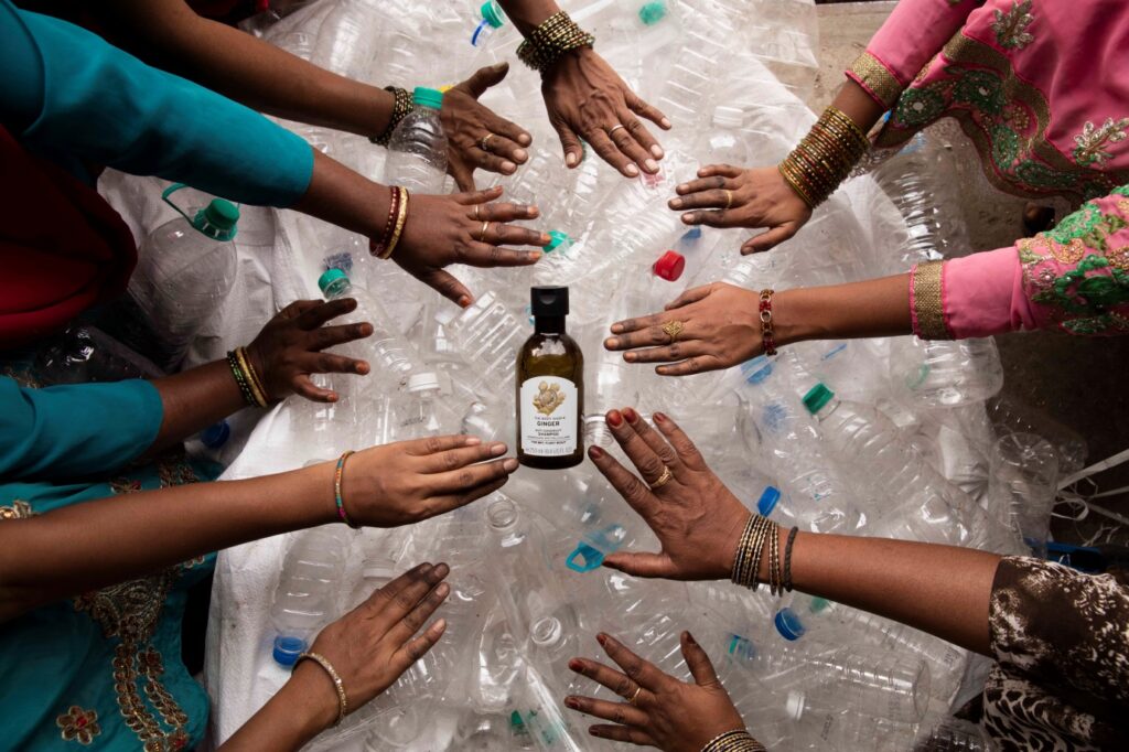 Women sorting recycled plastic bottles to promote plastic recycling, waste management, and a circular economy initiative.