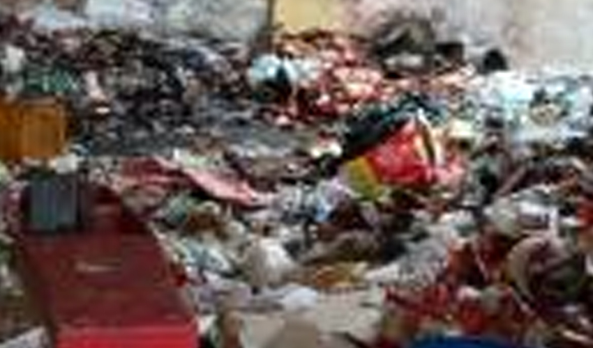 Overflowing garbage dump with mixed solid waste highlighting poor waste management and environmental pollution.