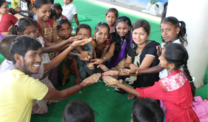 Children and volunteers participating in a community engagement activity promoting education, teamwork, and social development.