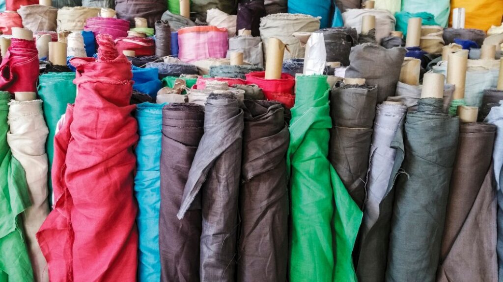 Recycled textile fabric rolls prepared for reuse through sustainable textile recycling and waste management.