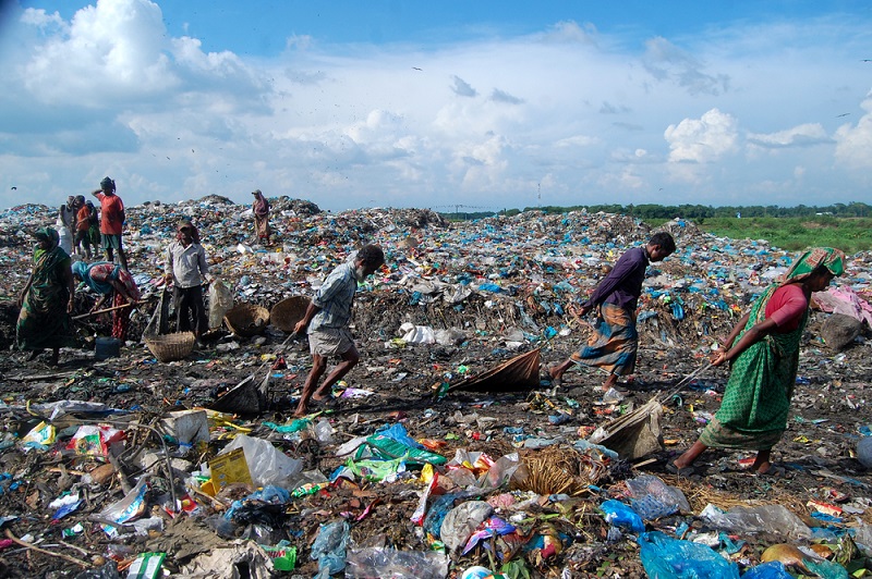 Waste pickers collecting recyclable materials at a landfill to support recycling and sustainable waste management.