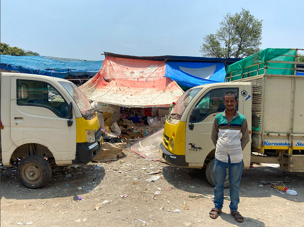 Waste collection vehicles at a recycling community supporting sustainable waste management in Bengaluru