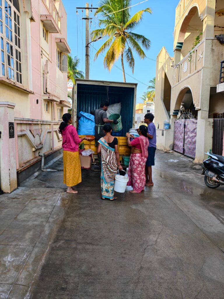Residents handing over segregated wet waste to Green Collar® collection staff during door-to-door waste collection